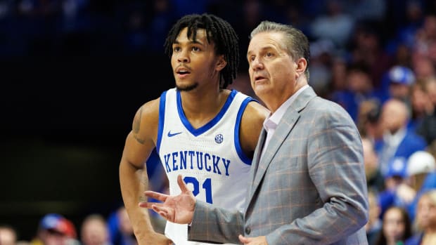 Nov 20, 2023; Lexington, Kentucky, USA; Kentucky Wildcats guard D.J. Wagner (21) talks with head coach John Calipari during overtime against the Saint Joseph's Hawks at Rupp Arena at Central Bank Center. Mandatory Credit: Jordan Prather-USA TODAY Sports